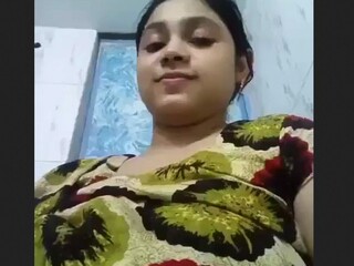 Watch as a chesty woman flaunts her breasts in the bathroom